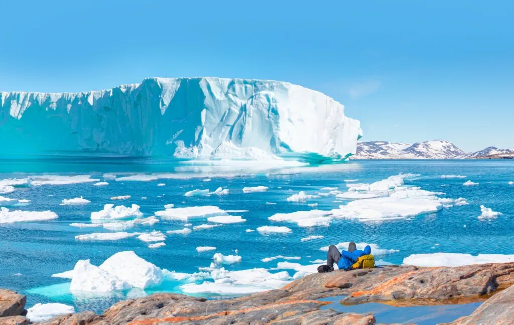 Environmental,Concept, ,A,Man,Hiker,Looking,At,Melting,Glacier